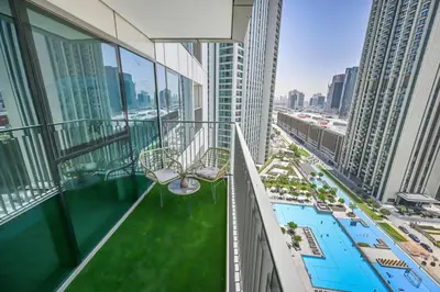 a balcony of a building with a swimming pool at DTV 2BR Burj View, Pool in Dubai