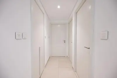 an empty hallway with white walls and white floors at DTV 2BR Burj View, Pool in Dubai