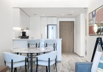 a kitchen and dining room with a table and chairs at Waterfront 1BR - Canal View - Fully Furnished in Dubai