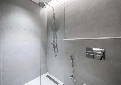 a bathroom with a shower with a glass door at Waterfront 1BR - Canal View - Fully Furnished in Dubai