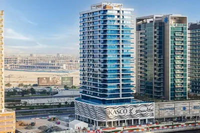 a tall blue and white building in a city at Tranquil Haven Near Burj Khalifa in Dubai