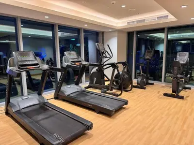a gym with several exercise bikes in a room at Tranquil Haven Near Burj Khalifa in Dubai