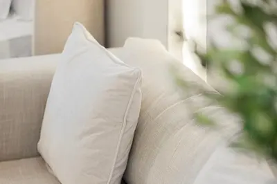 a white pillow on a couch in a living room at Tranquil Haven Near Burj Khalifa in Dubai