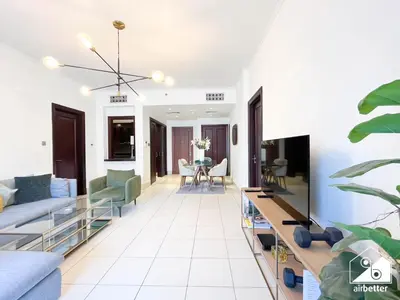 a living room with a couch and a table at Burj Views from Balcony l Chic 2BR in Downtown in Dubai