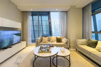 a living room with a couch and a tv at Modern Living with Canal Views, Near Burj Khalifa and World Trade Center in Dubai