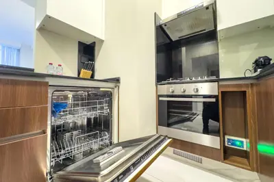 a kitchen with an oven with a dishwasher at Modern Living with Canal Views, Near Burj Khalifa and World Trade Center in Dubai