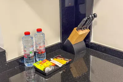 a counter with two bottles of water and a knife at Modern Living with Canal Views, Near Burj Khalifa and World Trade Center in Dubai
