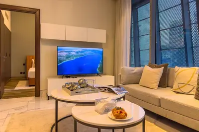 a living room with a couch and a flat screen tv at Modern Living with Canal Views, Near Burj Khalifa and World Trade Center in Dubai