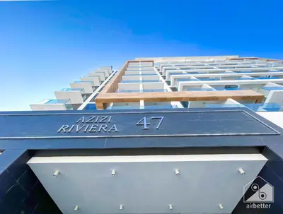 a building with a blue roof on top of it at Luxury & City Views Studio in Azizi Riviera in Dubai
