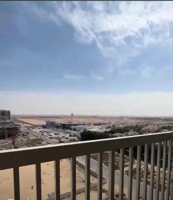 a balcony with a view of a parking lot at Dubailand in Dubai