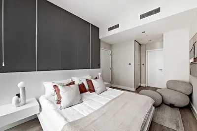 a bedroom with a large white bed with pillows at Luxury living , Triple pool access at Marina views in Dubai