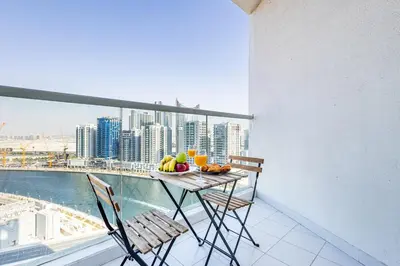 a table and chairs on a balcony with a view of a city at Elegant Studio Business Bay - Balcony with Skyline Views in Dubai