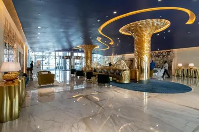 a lobby with gold columns and chairs in a building at Elegant Studio Business Bay - Balcony with Skyline Views in Dubai