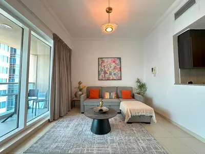 a living room with a couch and a table at Stylish 1BR Apt with Canal Views in Dubai