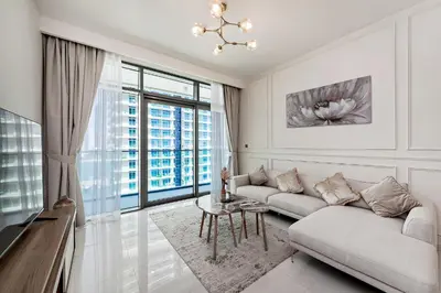 a living room with a couch and a table at 2 BR, private beach access, sea view, Emaar beach front in Dubai