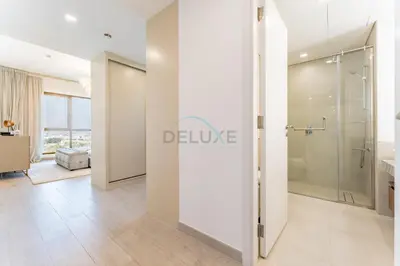 a bathroom with a shower and a glass door at Balcony Overlooking Community 2BR with Assistant Room, Minutes Away From the Beach, Madinat Jumeirah Living Rahaal 2, Jumeirah by Deluxe Holiday Homes in Dubai