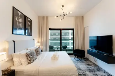 a bedroom with a large bed and a television at Modern Studio in Elite Business Bay Residence in Dubai
