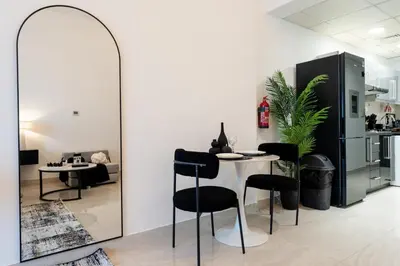 a room with a table and chairs and a mirror at Modern Studio in Elite Business Bay Residence in Dubai