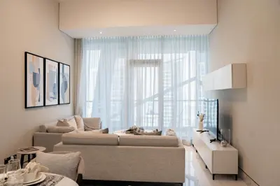 a living room with two couches and a large window at Experience Modern Comforts Near Iconic Dubai Mall and Burj Khalifa in Dubai
