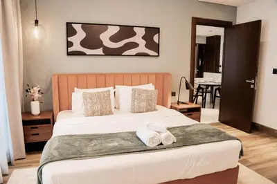 a bedroom with a bed with two towels on it at Experience Modern Comforts Near Iconic Dubai Mall and Burj Khalifa in Dubai
