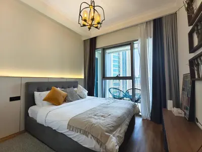 a bedroom with a large bed with a large window at Downtown Views 2 - Burj Khalifa View in Dubai