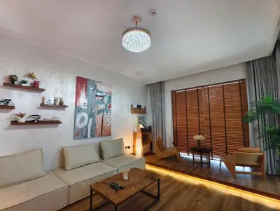 a living room with a couch and a table at Downtown Views 2 - Burj Khalifa View in Dubai