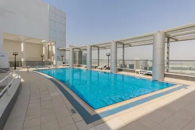 a large swimming pool on top of a building at Stunning Studio in Burj Al Nujoom in Dubai