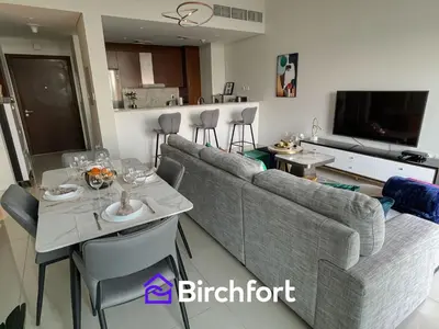 a living room with a couch and a table at Birchfort - Elegant 1BR Furnished at Mulberry in Dubai