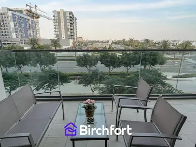 a balcony of a building with chairs and a table at Birchfort - Elegant 1BR Furnished at Mulberry in Dubai