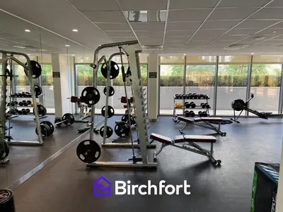 a gym with several tread machines in a room at Birchfort - Elegant 1BR Furnished at Mulberry in Dubai