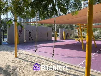 a swing set in a park with a playground at Birchfort - Elegant 1BR Furnished at Mulberry in Dubai