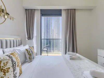 a bedroom with a large bed with a large window at TRPS - Act One Act Two Towers, Downtown Dubai, Iconic 3BR plus Maids - with Burj Khalifa Views - Near Dubai Mall in Dubai