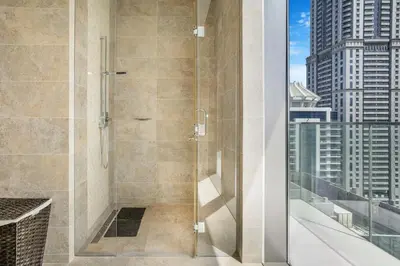 a shower stall with a view of a city at Marina Gate 2 Penthouse Iconic Views in Dubai