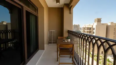 a balcony with a table and a view of a city at 1br Luxury Complex Burj AlArab View 5min to beach in Dubai