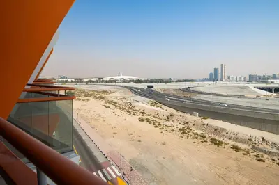 a view of a dirt road with a highway at Stylish Studio Apartment in Binghatti Crystals in Dubai