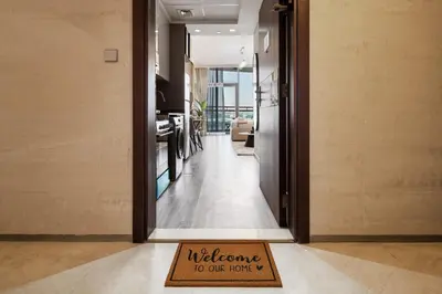a welcome to our hotel sign on a floor in a hallway at Stylish Studio Apartment in Binghatti Crystals in Dubai