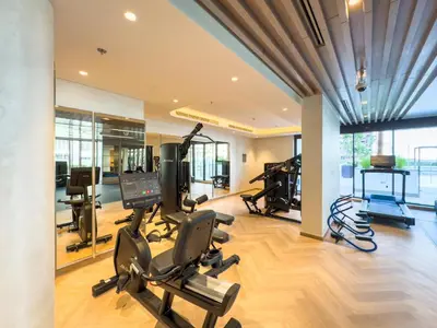 a gym with treadmills and exercise bikes in a room at Elegant 1-Bed with Pool, Gym, Parking and Balcony in Dubai