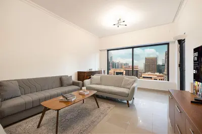 a living room with a couch and a table at Prime Location - Marina full View - Perfect for holidays in Dubai