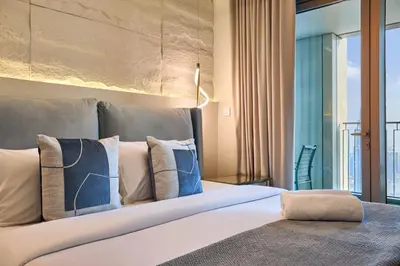 a bedroom with a large bed with a large window at Luxury 4 Bedroom High-Floor Apartment, Spectacular Burj Khalifa & Fountain Views, Steps Away from Dubai Mall - Downtown Dubai by Stayfinity in Dubai