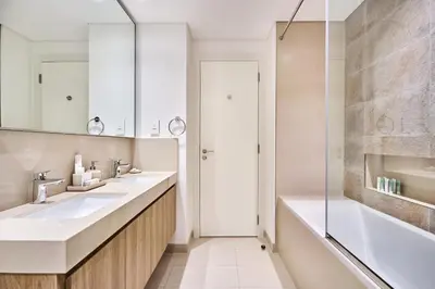 a bathroom with two sinks and a shower at Luxury 4 Bedroom High-Floor Apartment, Spectacular Burj Khalifa & Fountain Views, Steps Away from Dubai Mall - Downtown Dubai by Stayfinity in Dubai