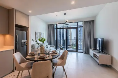 a kitchen and dining room with a table and chairs at Alluring 1BDR apartment in Dubai Creek Harbour in Dubai