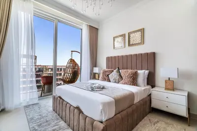 a bedroom with a large bed with a large window at Elegant 1BR Apartment with Private Beach Access! in Dubai