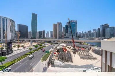 a construction site in a city with a freeway at Modern 2BR with Private Terrace, Pool and Gym Access in Dubai