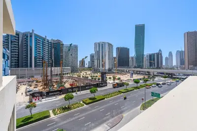 a view of a street in a city with tall buildings at Modern 2BR with Private Terrace, Pool and Gym Access in Dubai