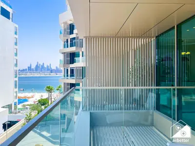 an apartment balcony with a view of the ocean at High End 1BR Palm Beachfront Pool Access in Dubai