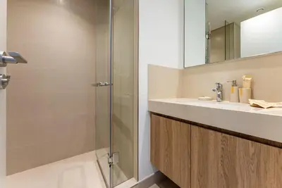 a bathroom with a sink and a shower at Downtown Views II 2 Bedroom with City Skyline and Sea Views in Dubai