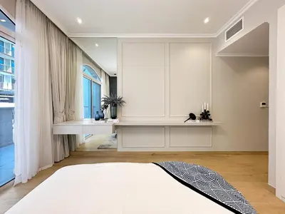 a bedroom with a white bed and a window at Elegant 2BR Plus Guest Room Stay with Designer Interior in Dubai