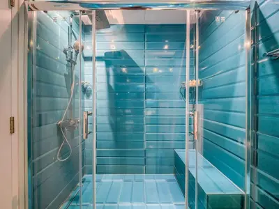 a bathroom with a shower with blue tiles at TRPS - Marina Heights Tower, Dubai Marina - 2BR Upgraded Apartment - with Stunning Marina Skyline in Dubai