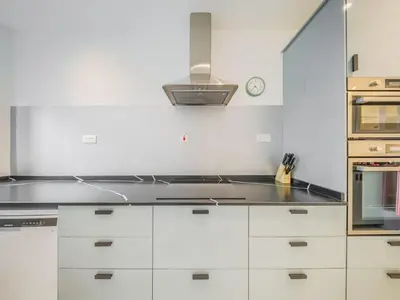 a kitchen with white cabinets and a stove at TRPS - Marina Heights Tower, Dubai Marina - 2BR Upgraded Apartment - with Stunning Marina Skyline in Dubai