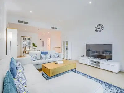 a living room with a white couch and a table at TRPS - Marina Heights Tower, Dubai Marina - 2BR Upgraded Apartment - with Stunning Marina Skyline in Dubai